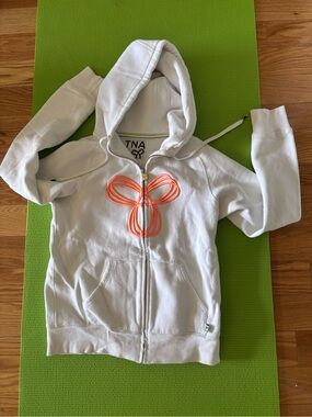 TNA White Zip Hoodie with Coral Bow Accent